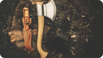 bushcraft tools-axe and knife on a stump