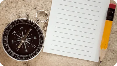 compass and a notepad and pencil