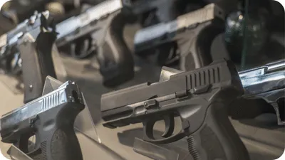 Handguns in a gun store in a display case
