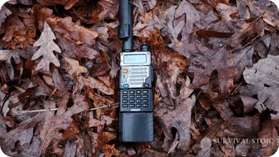 Handheld ham radio outside laying on the ground in leaves