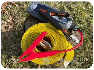 tow strap and jump start box on a stump