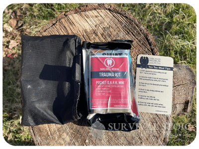 opened Individual first aid kit on a stump