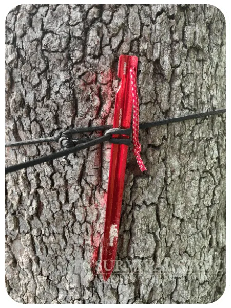 Tent stake used as a marlinespike hitch around a tree