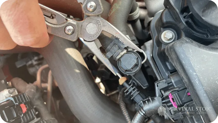 Jason working on a disabled vehicle with a multitool
