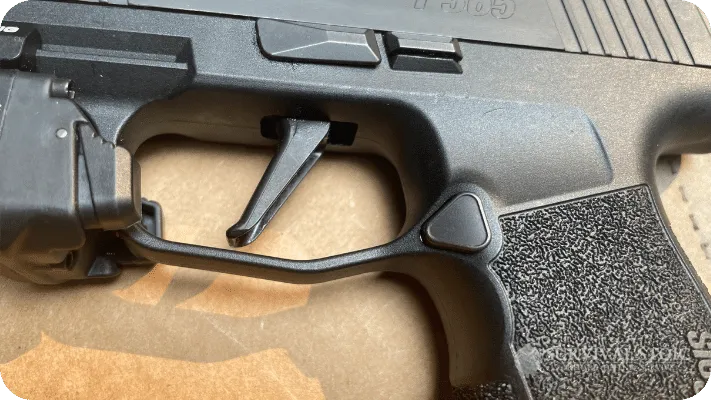 The author showing the flat trigger on the Sig P365XL