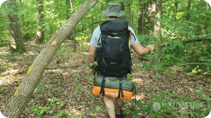 The author walking in the woods with the Osprey Kestrel 38 Backpack