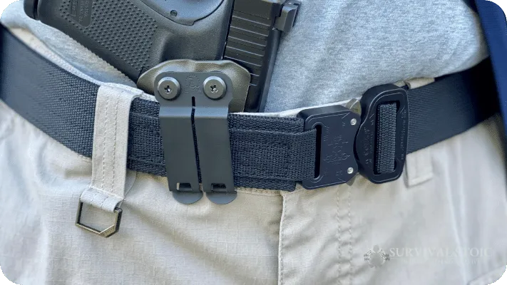 Jason demonstrating how to wear a concealed carry holster with a gun belt and shirt