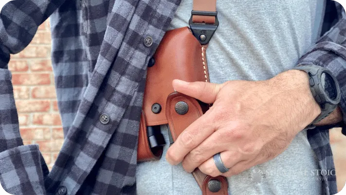 The author showing the mag carriers on the shoulder holster