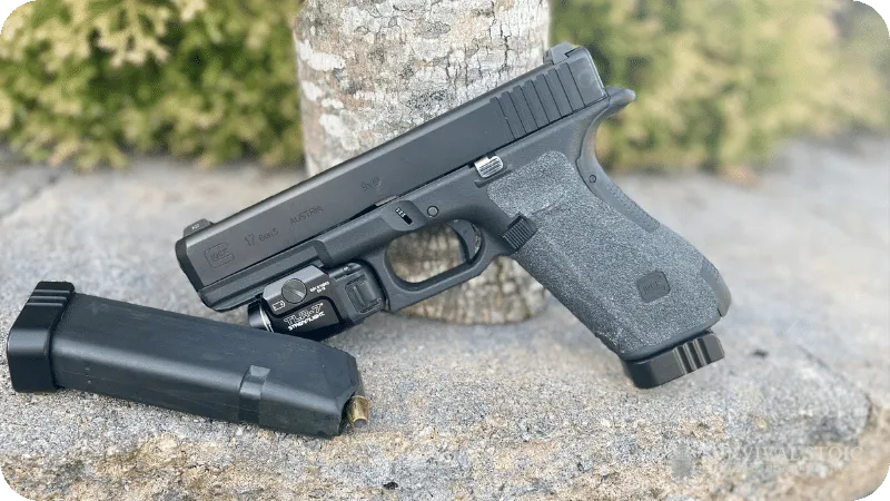 Jason's Glock 17 with a rail mounted light and a magazine