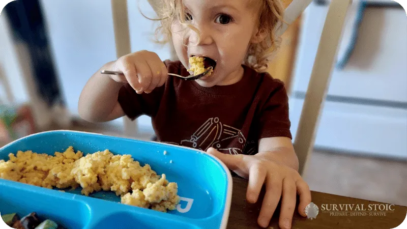 A Child eating the Nutrient Survival Powdered Egg Blend
