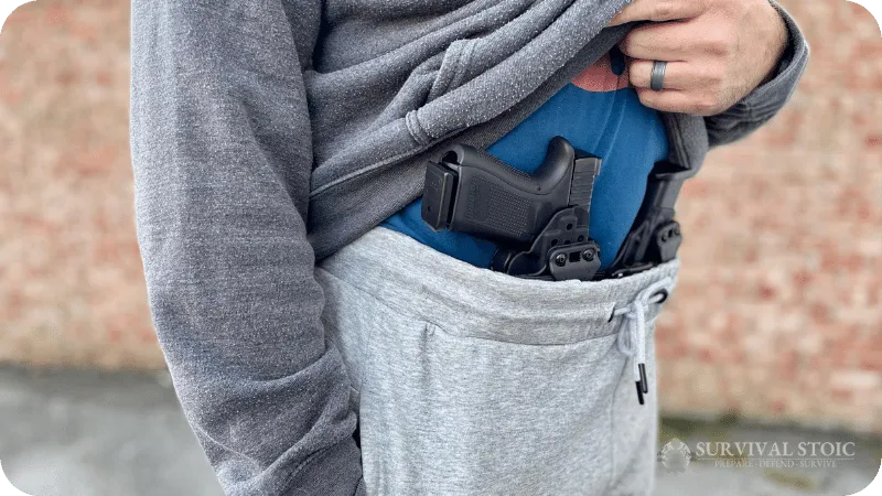 Jason wearing the arrowhead tactical joggers with an Alien Gear holster and Glock 19