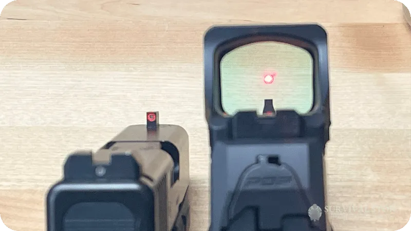 Jason showing looking down the sights of an iron sight handgun and a red dot handgun